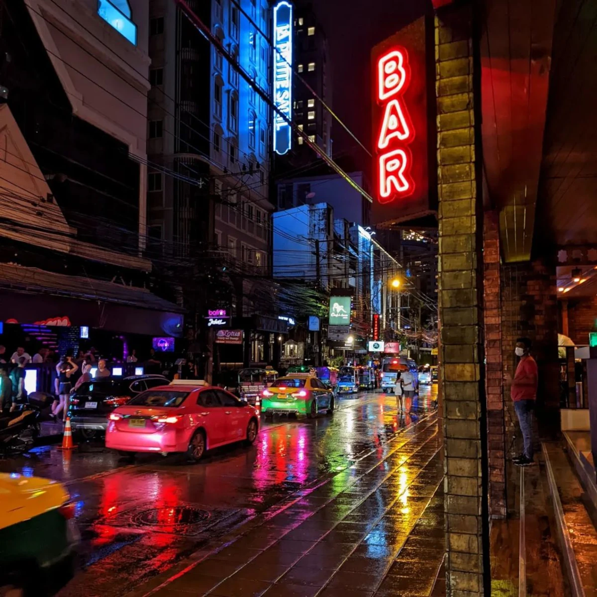 Colorful bar sign on Sukhumvit Soi 11, Bangkok, a popular nightlife street.