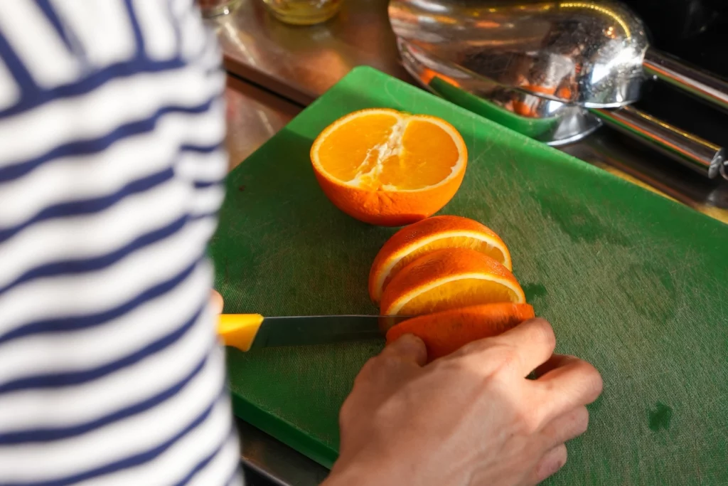 barback cutting an orange at Pastel Bangkok rooftop bar and restaurant