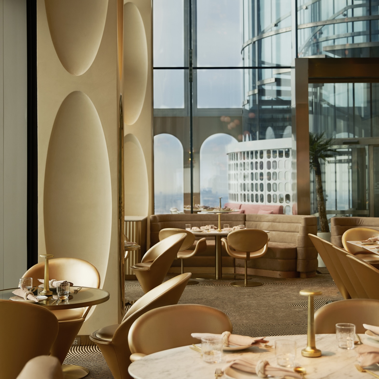 Captivating interior design at Ojo Restaurant Bangkok, featuring glamorous gold and pink color scheme.