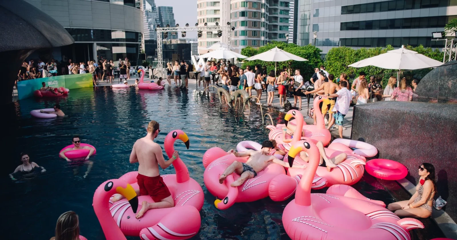 A big pool party at W Bangkok with a lot of people partying.