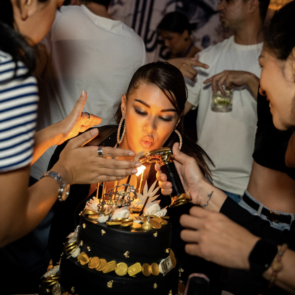 Thai model blowing up candles on a birthday cake during her birthday party at Pastel Bangkok