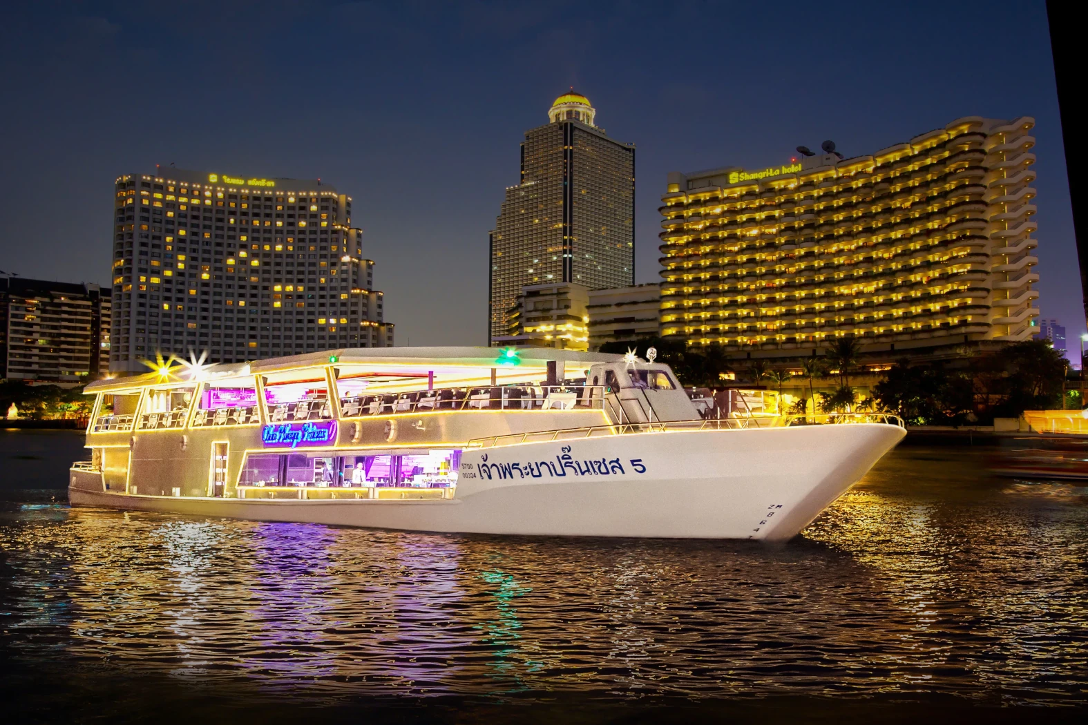 Chao Phraya dinner cruise boat adorned with lights.