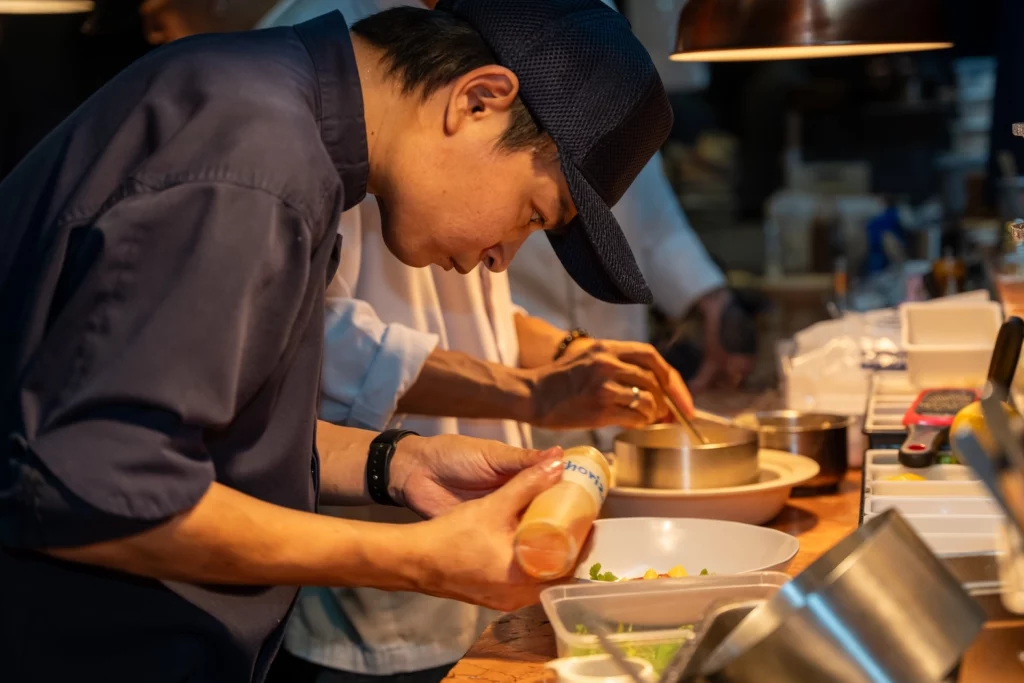 commis preparing a dish at Pastel Bangkok