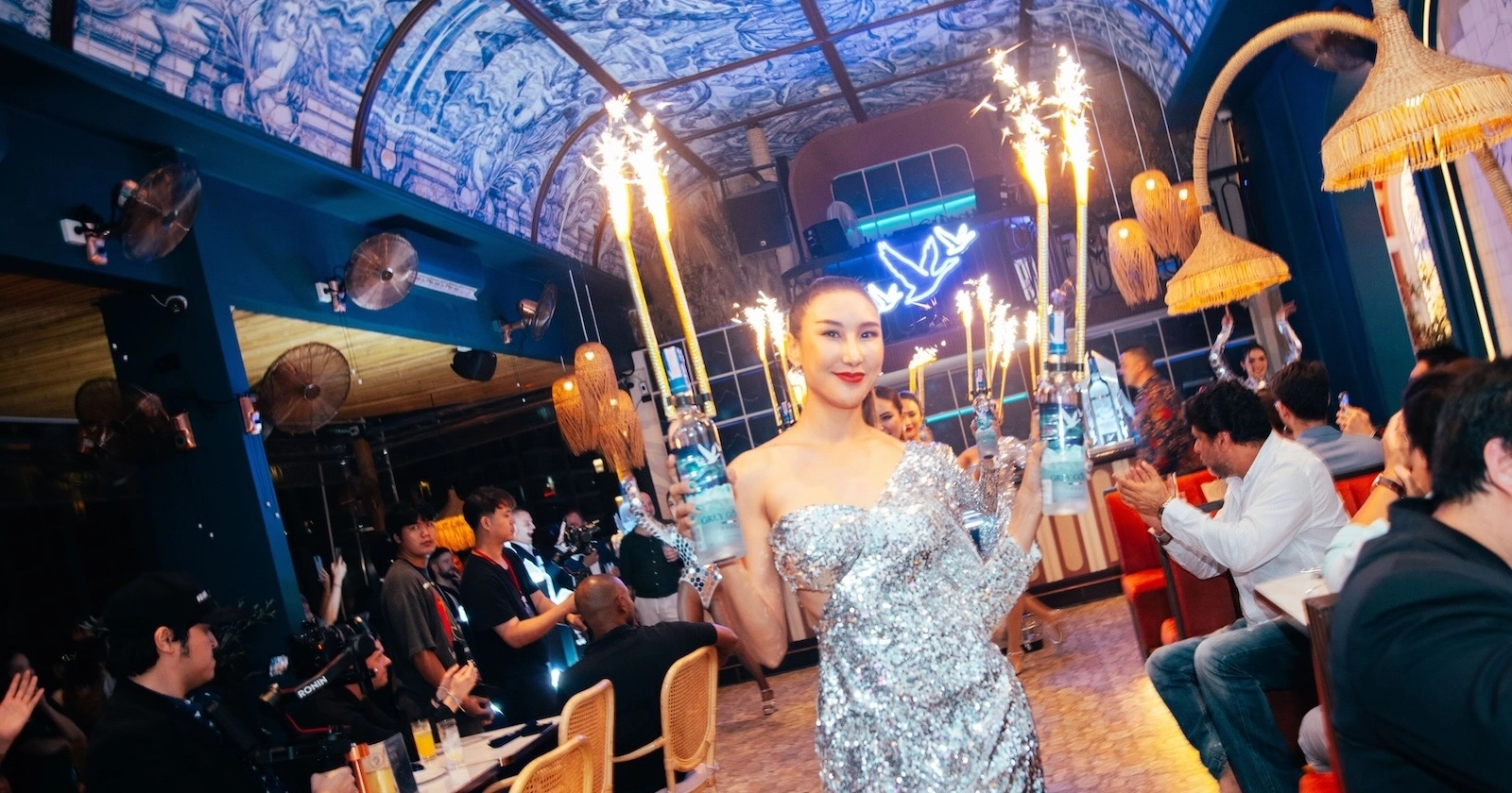 Thai model is holding bottles of Grey Goose with sparklers at Pastel rooftop bar in Sukhumvit Soi 11 in Bangkok Thailand during a corporate event and product launch for new Grey Goose bottles