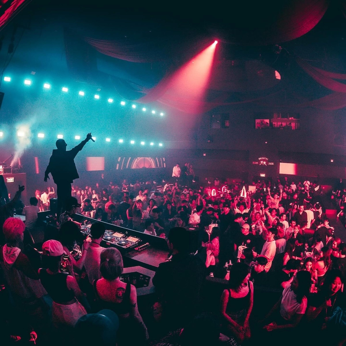 crowd cheering a DJ at MUIN Bangkok nightclub in the area of Thonglor