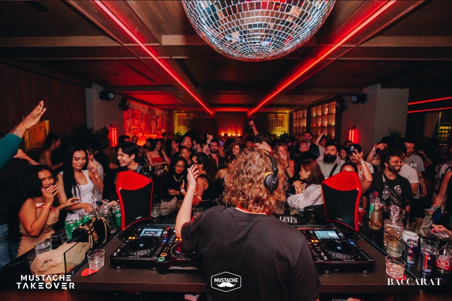 DJ playing in front of a crowd at Baccarat nightclub in Sukhumvit Soi 24 in Bangkok