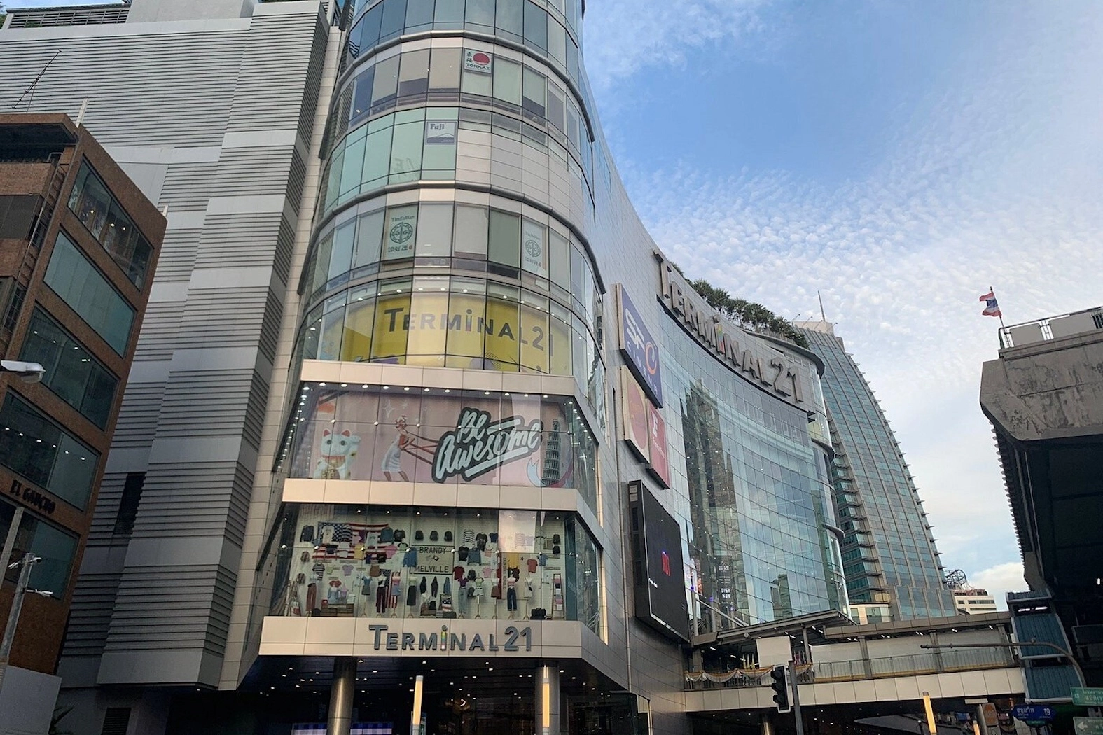 exterior of Terminal 21 mall in Bangkok near Asoke with the corner of the BTS station and a small flag of Thailand