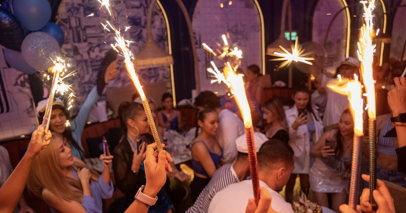 people holding flares during a VIP bottle service for a birthday party at Pastel Bangkok