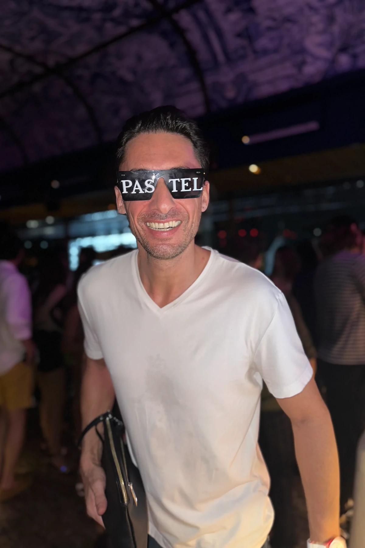 A guy smiling during the white party at Pastel Bar and Restaurant in Bangkok.
