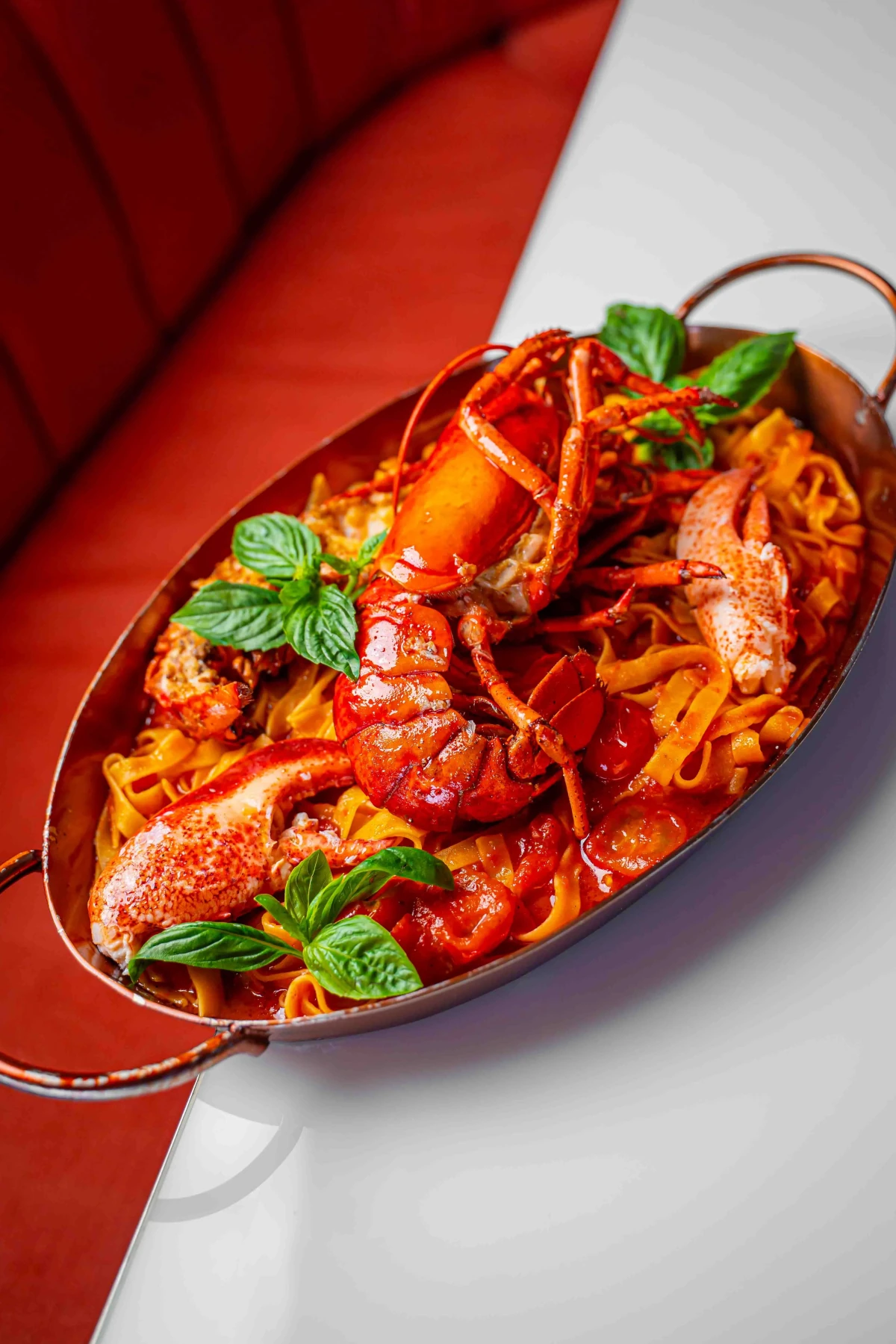 Italian plate with pasta and lobster at Pastel Rooftop Bar in Bangkok.