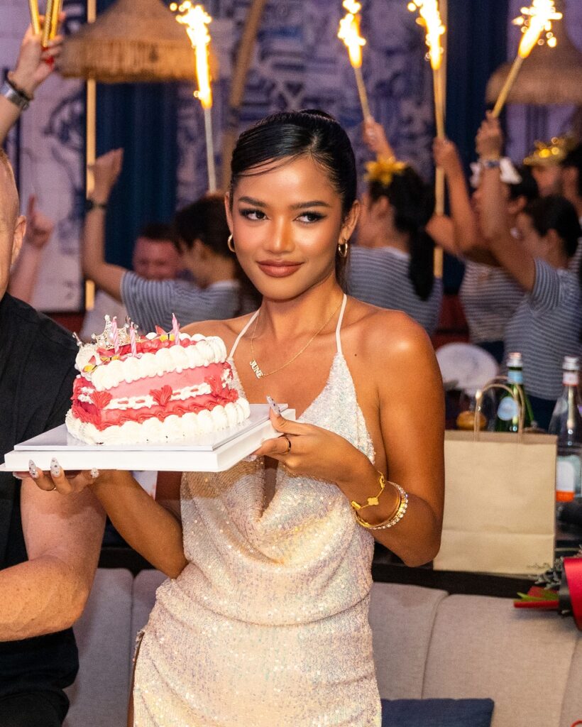 beautiful young Thai girl holding a birthday cake at Pastel Bangkok rooftop bar and restaurant in Bangkok