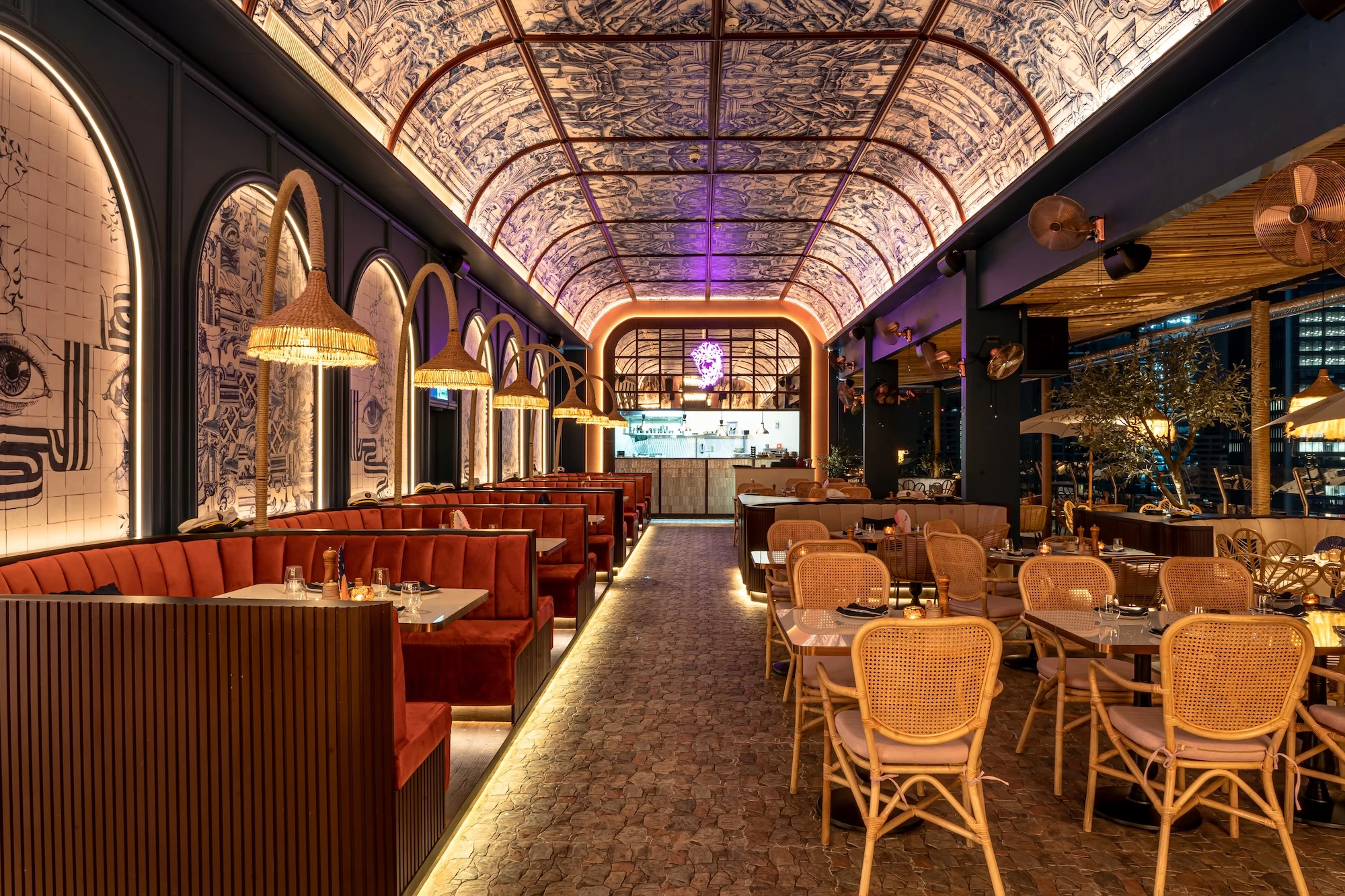 At night, Pastel Bangkok Rooftop Bar and Restaurant features a unique ceiling design and soft lighting, creating a warm and inviting space for dining