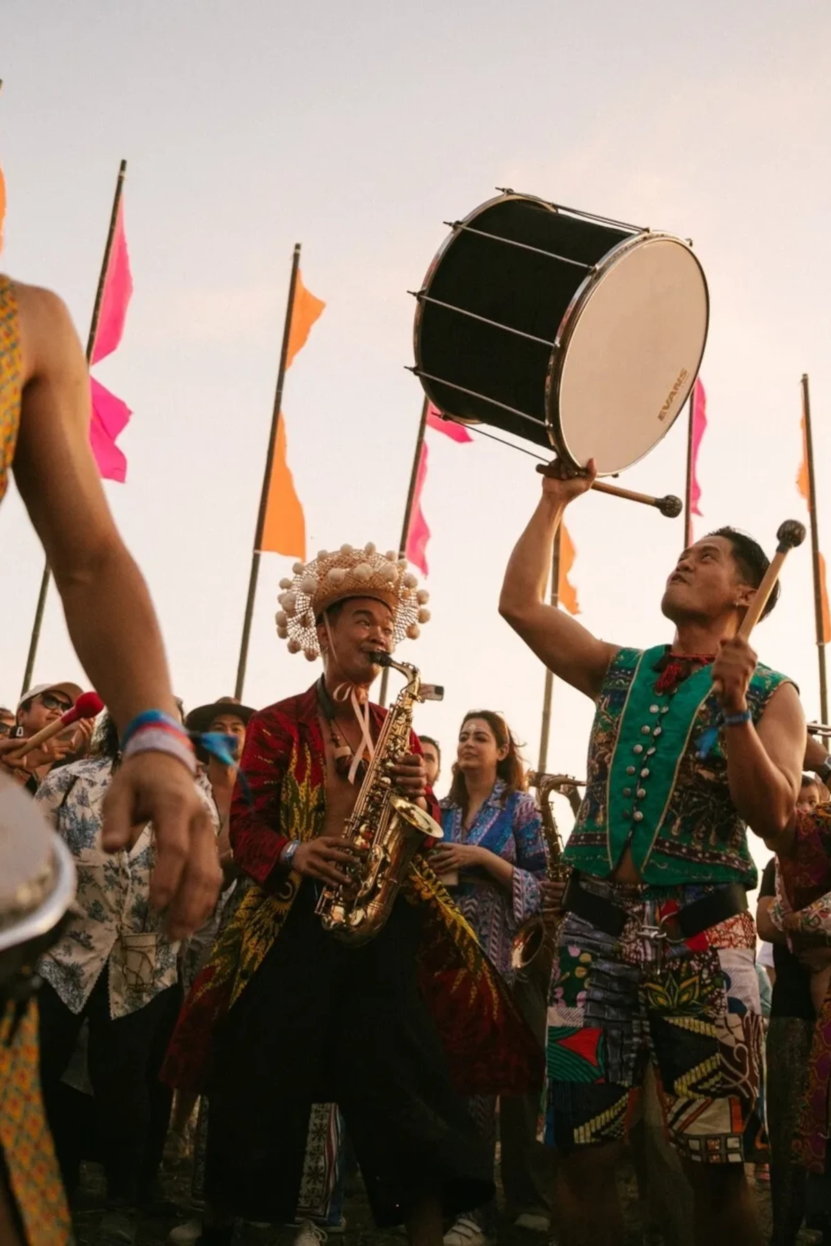 People playing instruments and enjoying the atmosphere at the Wonderfruit Music Festival in Thailand.