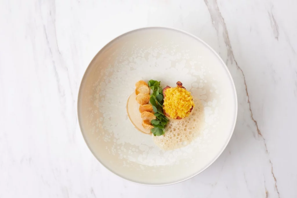 Picture of a delicious dish seared atlantic scallop jerusalem artichoke at Chef's table restaurant in Bangkok