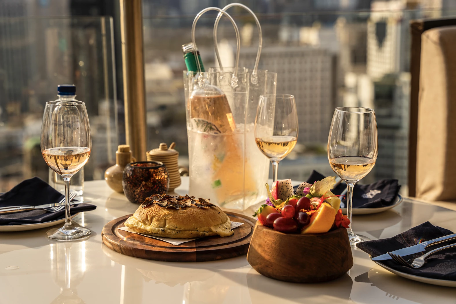 table with wine and starters during the sunset at Pastel Bangkok