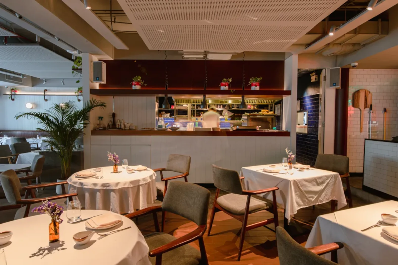 Tony's Bangkok restaurant with romantic table and open kitchen